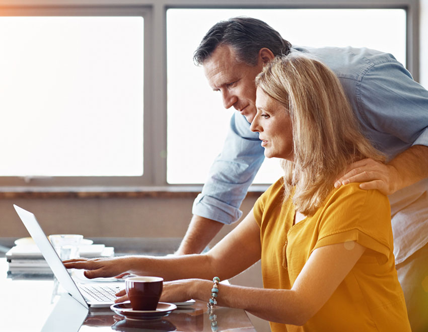 two people with laptop